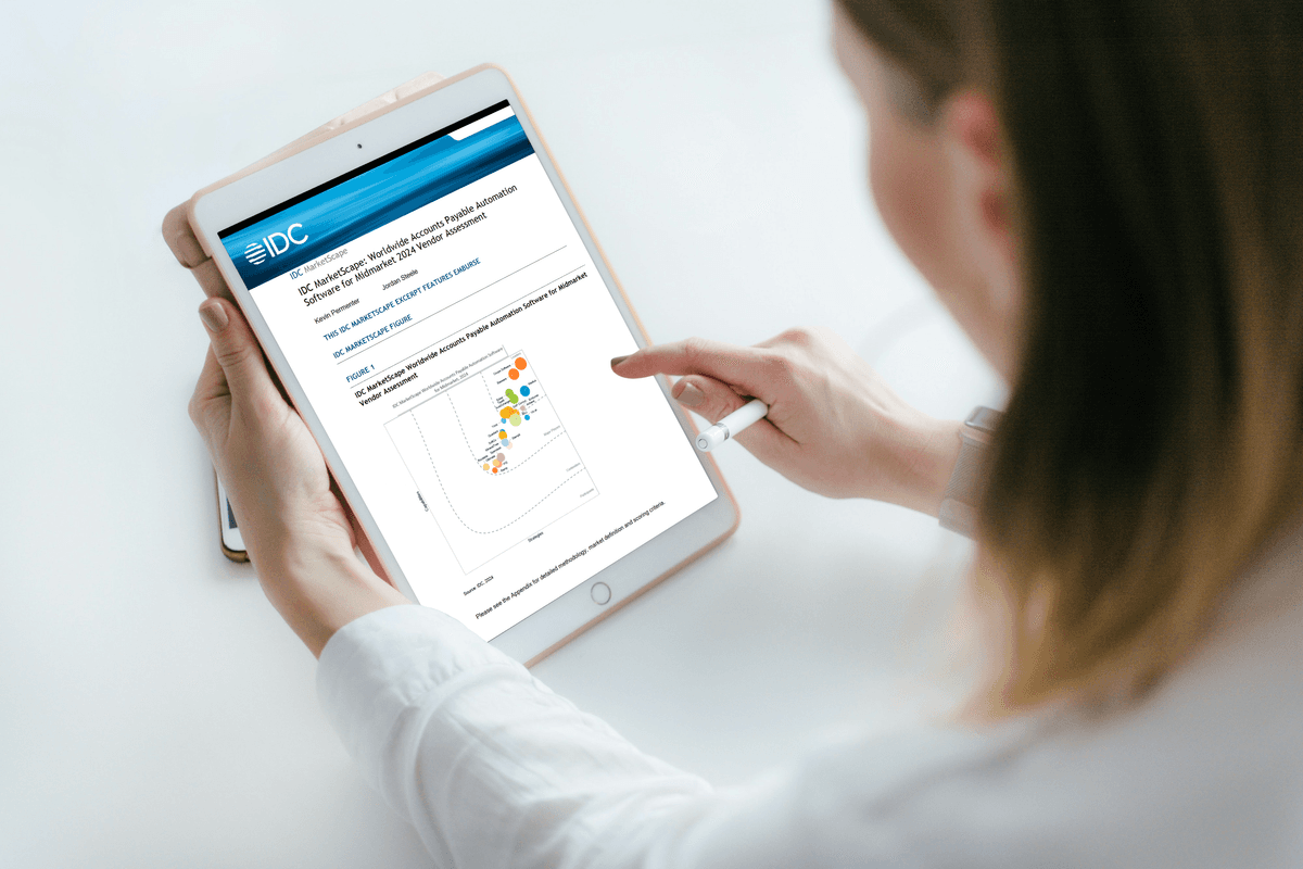 a woman is holding a tablet that says idc on the screen