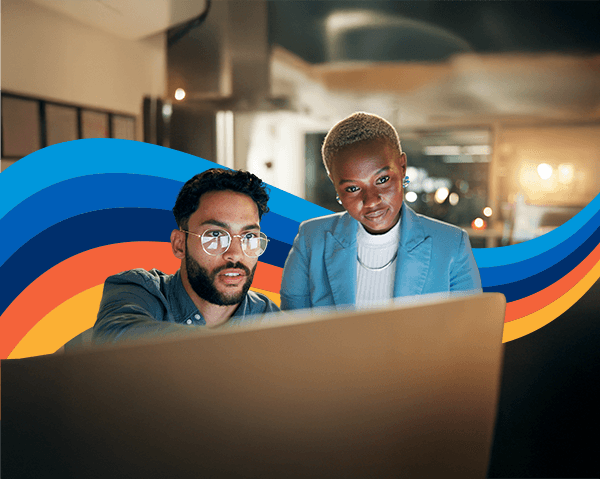 a man and a woman are looking at a computer screen