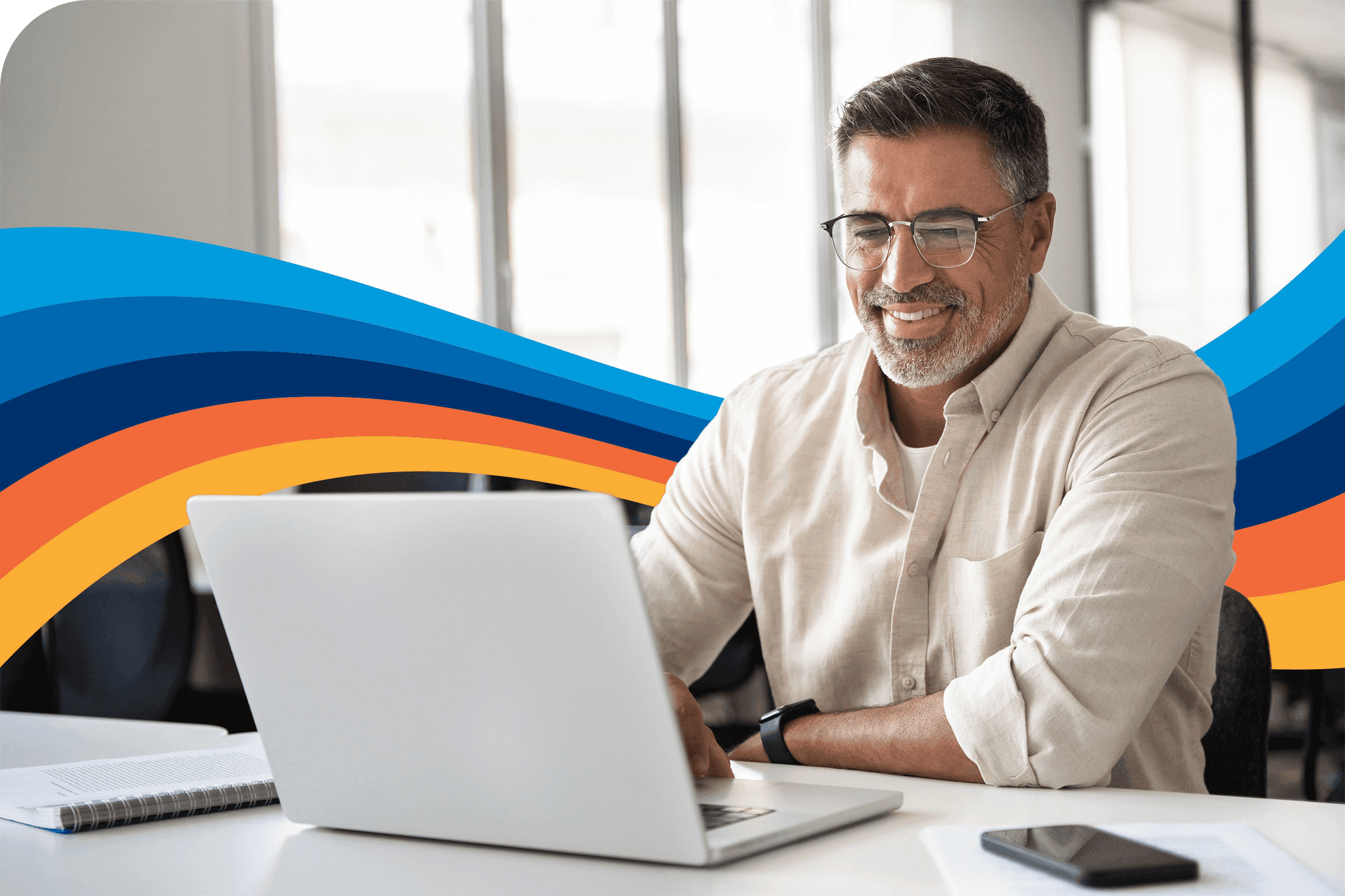 a man wearing glasses is using a laptop computer