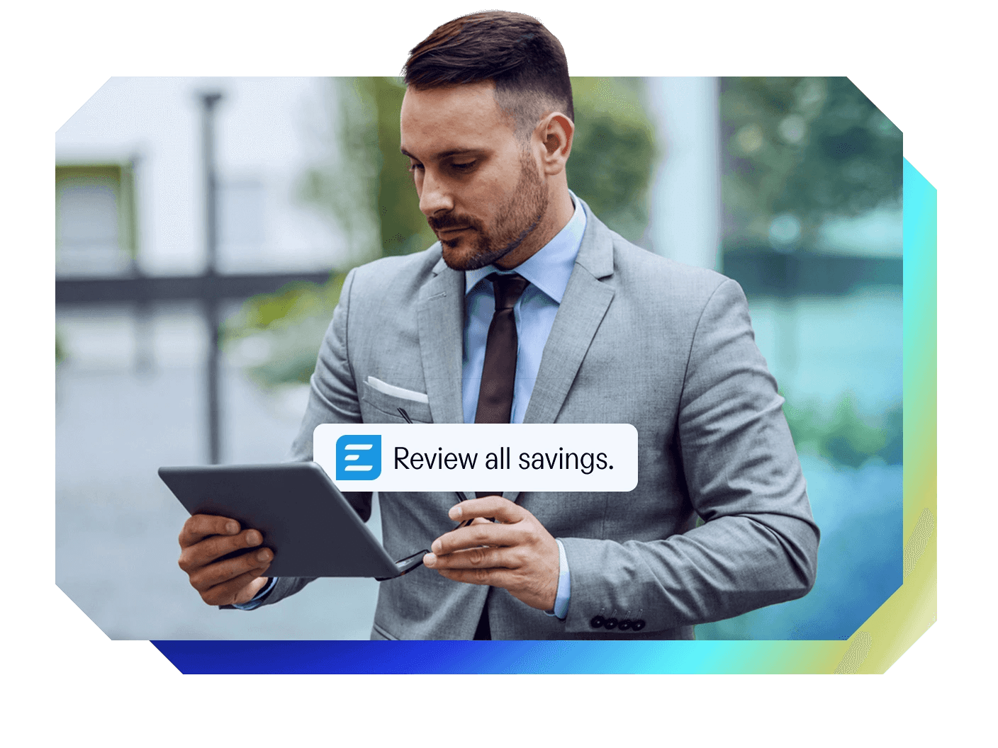a man in a suit is looking at a tablet with a review all savings notification