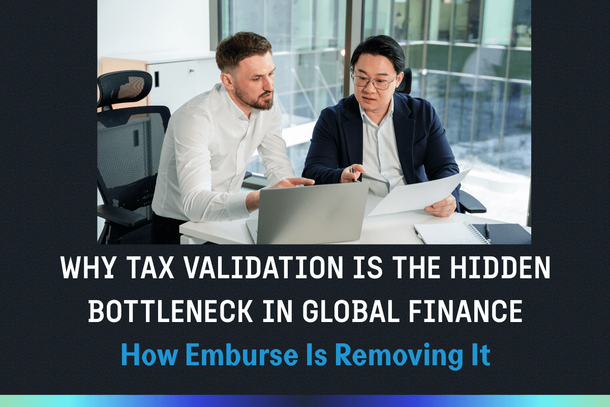 Two businessmen reviewing documents and a laptop at a desk.